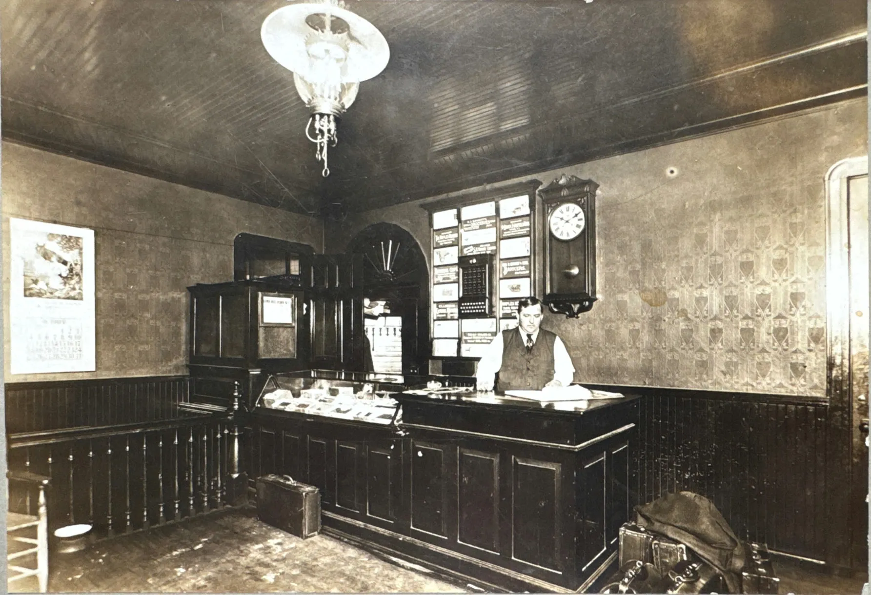 The Naples Hotel front desk in the early 1900s, the clerk at the registration counter