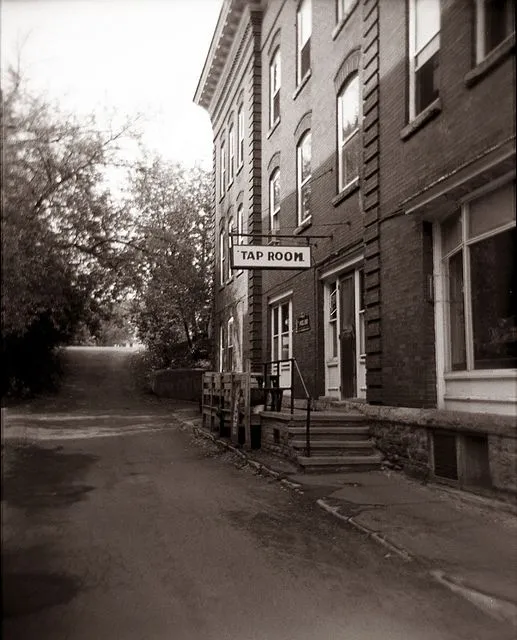 The original Tap Room entrance sign on the brick exterior