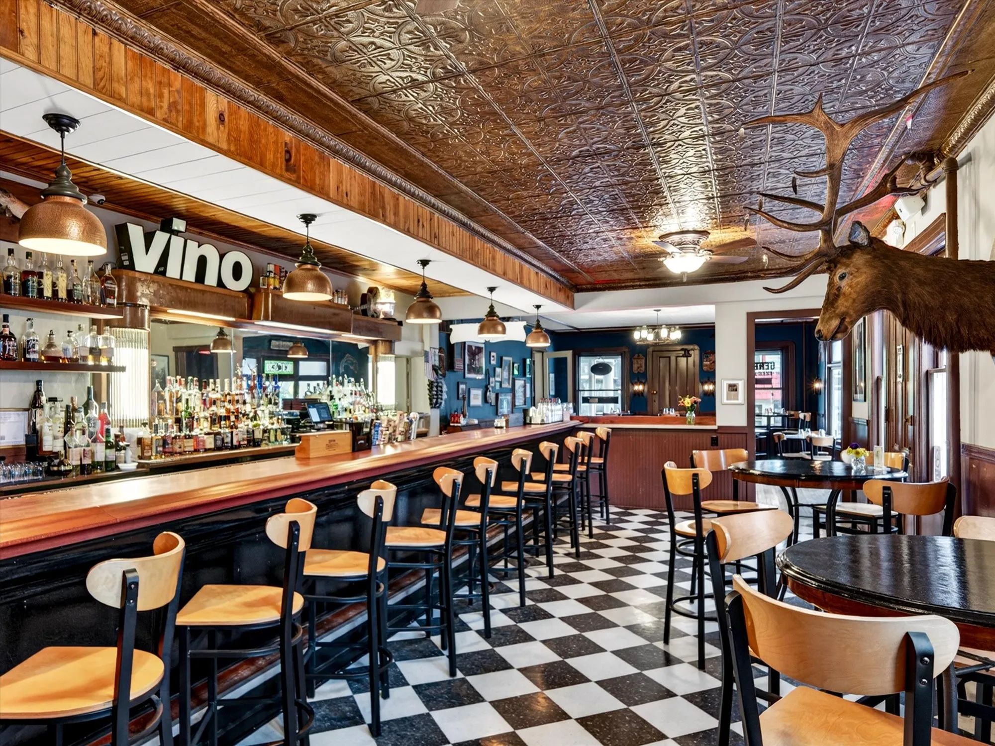 The Tap Room bar from the far end, with the vino sign